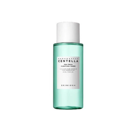 SKIN1004 Madagascar Centella Tea-Trica Purifying Toner is a refreshing and clarifying toner designed to soothe and balance the skin. It features 12% Tea Tree Leaf Water and 9.8% Centella Asiatica Extract to calm irritation and reduce redness while promoting a healthy skin barrier. Infused with Salicylic Acid, it gently exfoliates and helps unclog pores, making it ideal for acne-prone and sensitive skin. With added Lavender Extract and Castanea Crenata Shell Extract, it nourishes and refreshes, leaving your 